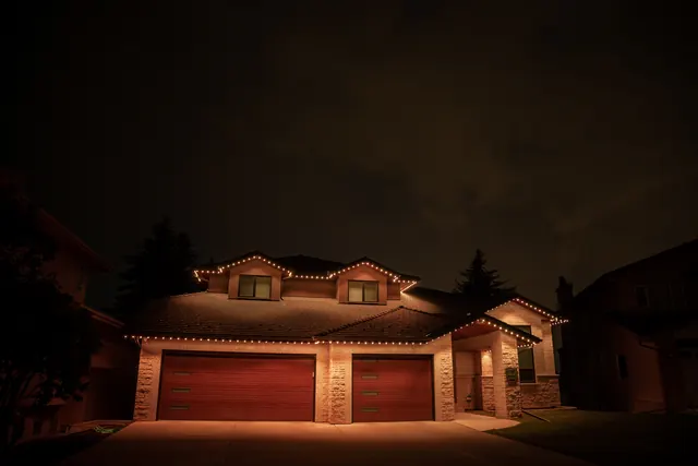 Warm white permanent roofline lighting on a Colorado home at night (photo 86 of 136)