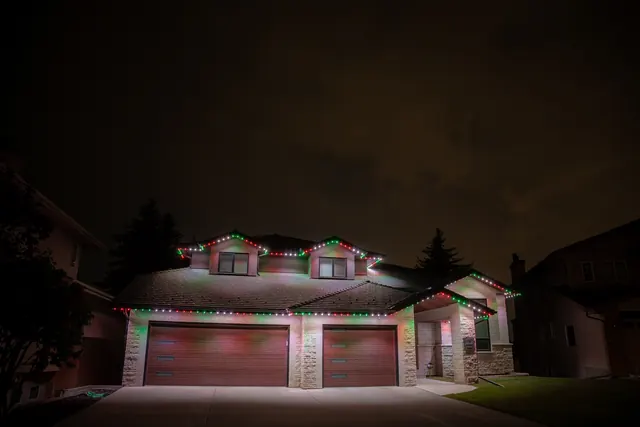 Warm white permanent roofline lighting on a Colorado home at night (photo 87 of 136)