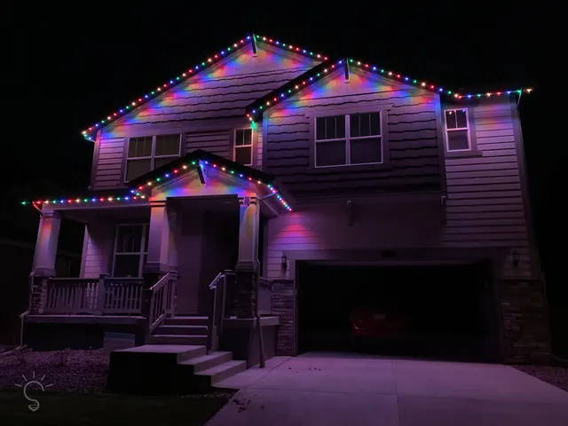 Warm white permanent roofline lighting on a Colorado home at night (photo 90 of 136)