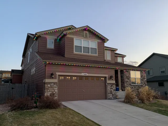 Warm white permanent roofline lighting on a Colorado home at night (photo 91 of 136)