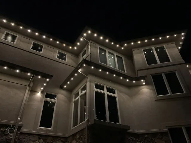 Warm white permanent roofline lighting on a Colorado home at night (photo 92 of 136)