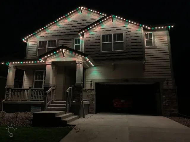 Warm white permanent roofline lighting on a Colorado home at night (photo 94 of 136)