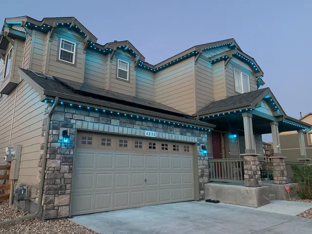 Warm white permanent roofline lighting on a Colorado home at night (photo 96 of 136)