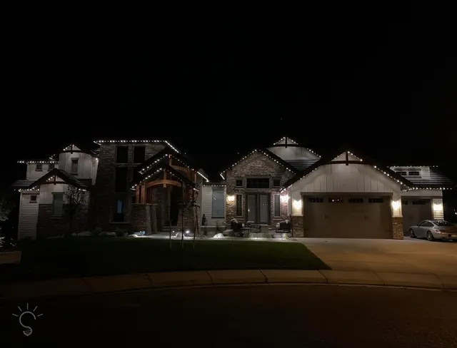 Warm white permanent roofline lighting on a Colorado home at night (photo 97 of 136)