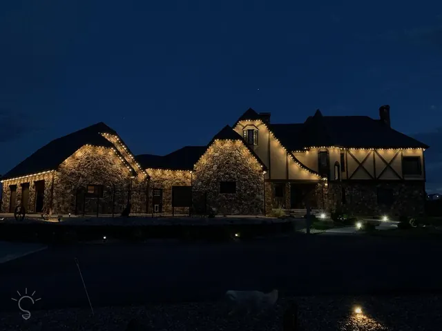 Warm white permanent roofline lighting on a Colorado home at night (photo 99 of 136)