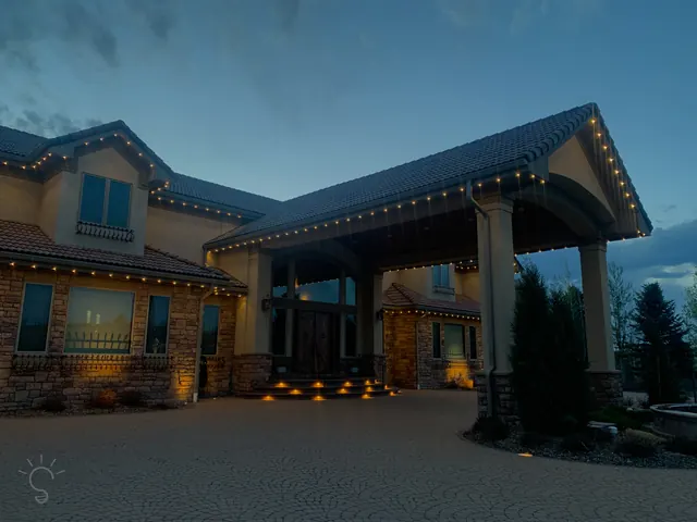 Warm white permanent roofline lighting on a Colorado home at night (photo 100 of 136)