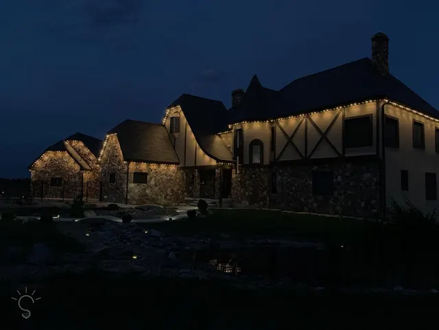 Warm white permanent roofline lighting on a Colorado home at night (photo 101 of 136)