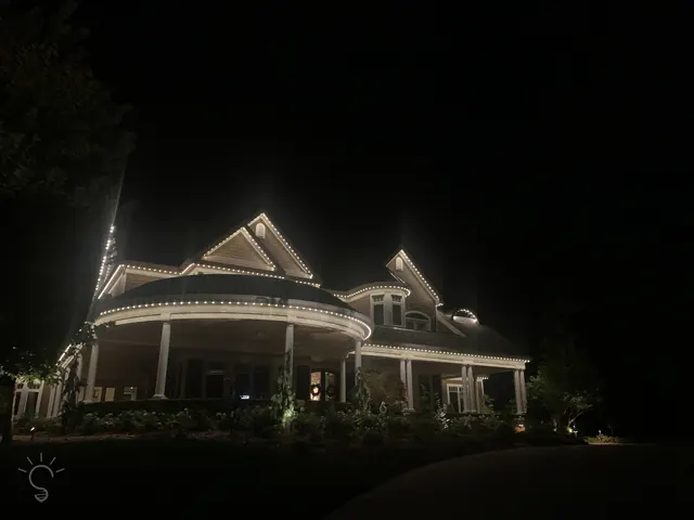 Warm white permanent roofline lighting on a Colorado home at night (photo 104 of 136)