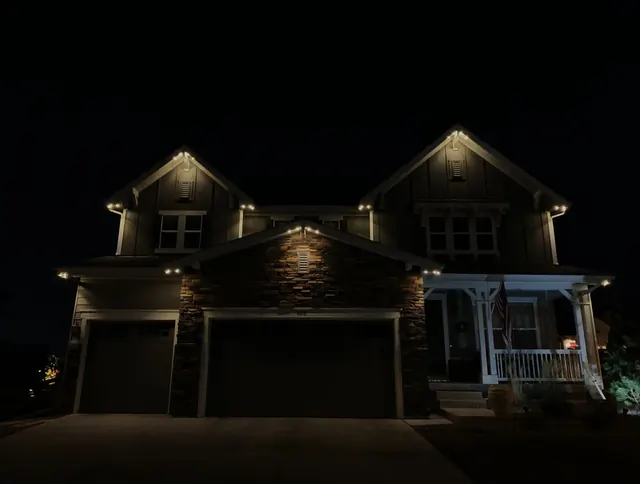 Warm white permanent roofline lighting on a Colorado home at night (photo 105 of 136)