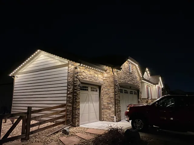 Warm white permanent roofline lighting on a Colorado home at night (photo 107 of 136)