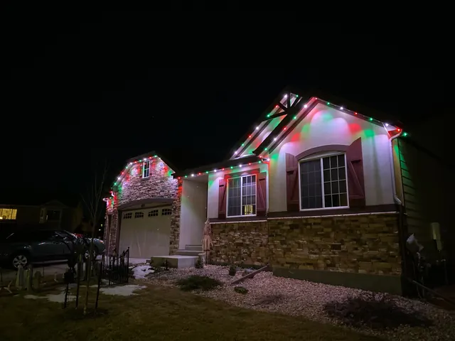 Warm white permanent roofline lighting on a Colorado home at night (photo 108 of 136)