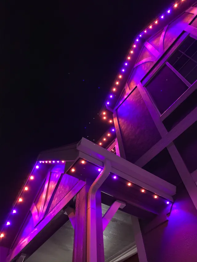Gemstone permanent roofline lights in holiday colors on a Colorado home (photo 110 of 136)