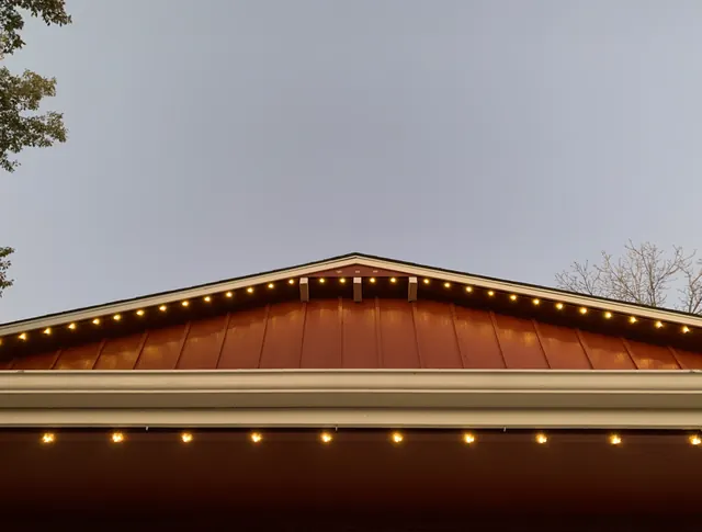 Warm white permanent roofline lighting on a Colorado home at night (photo 114 of 136)