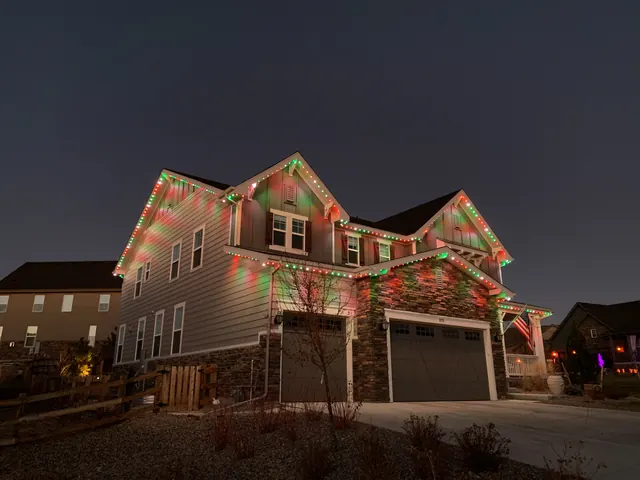 Warm white permanent roofline lighting on a Colorado home at night (photo 116 of 136)