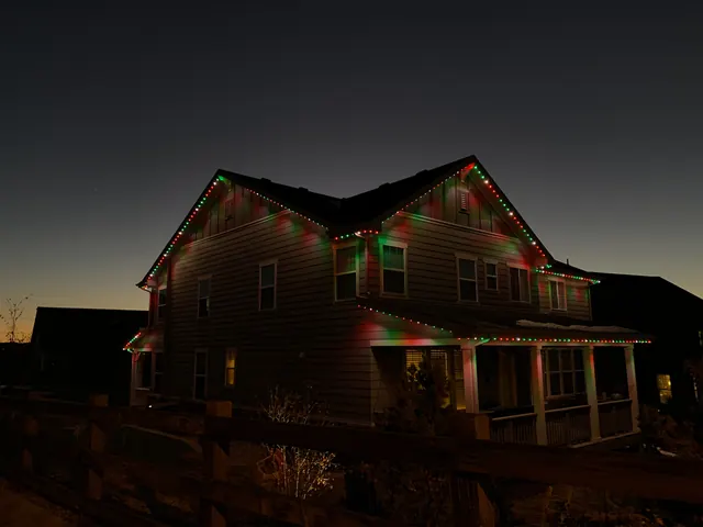 Warm white permanent roofline lighting on a Colorado home at night (photo 117 of 136)