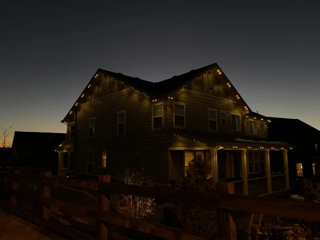 Warm white permanent roofline lighting on a Colorado home at night (photo 118 of 136)
