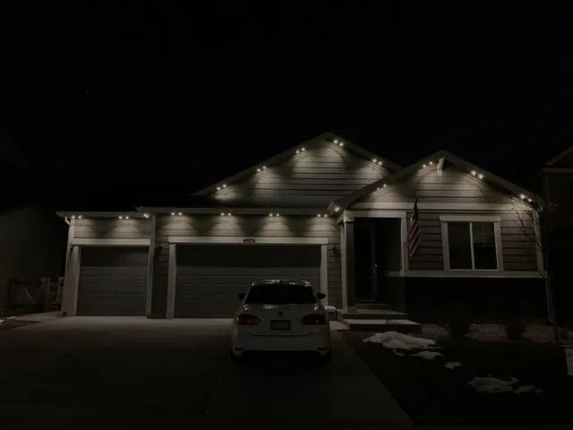 Warm white permanent roofline lighting on a Colorado home at night (photo 119 of 136)