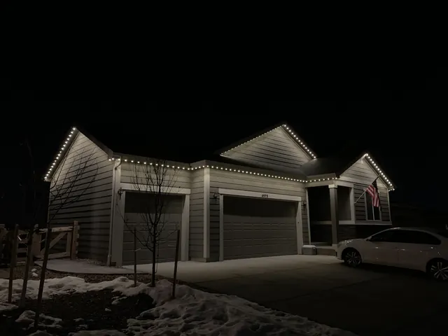 Warm white permanent roofline lighting on a Colorado home at night (photo 120 of 136)