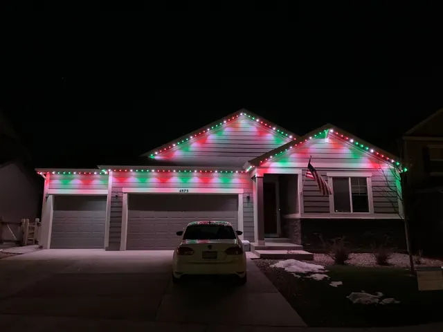 Warm white permanent roofline lighting on a Colorado home at night (photo 123 of 136)