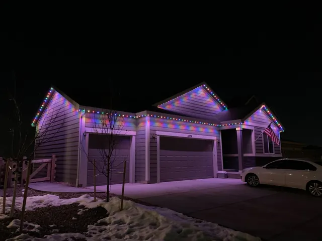 Warm white permanent roofline lighting on a Colorado home at night (photo 124 of 136)