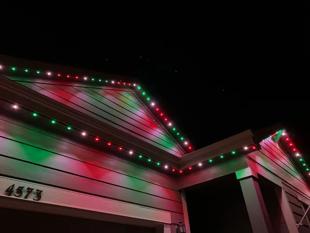 Warm white permanent roofline lighting on a Colorado home at night (photo 125 of 136)
