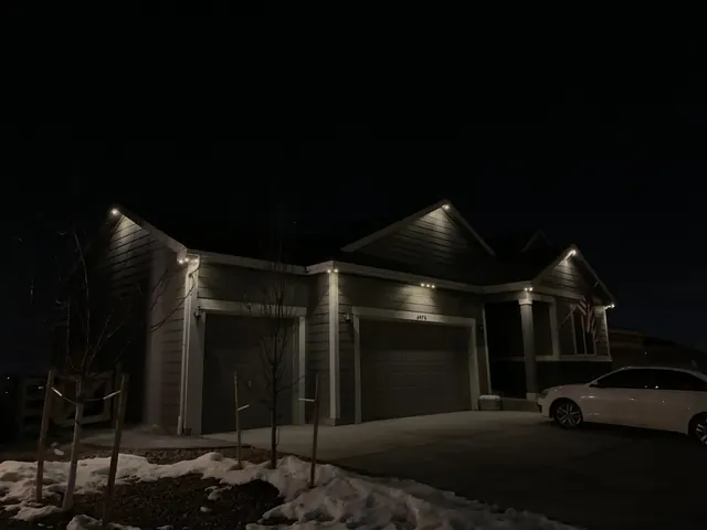Warm white permanent roofline lighting on a Colorado home at night (photo 126 of 136)
