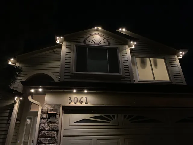 Warm white permanent roofline lighting on a Colorado home at night (photo 128 of 136)
