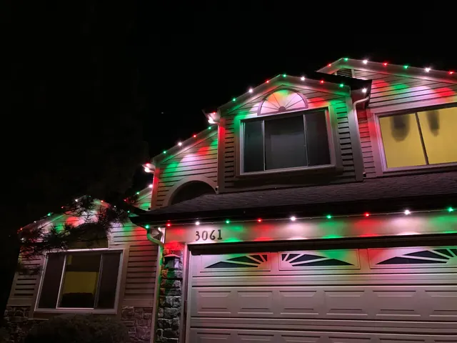 Warm white permanent roofline lighting on a Colorado home at night (photo 129 of 136)