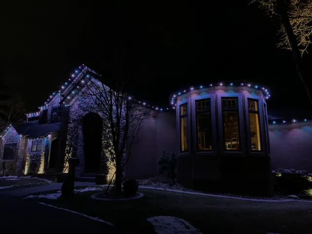 Warm white permanent roofline lighting on a Colorado home at night (photo 131 of 136)