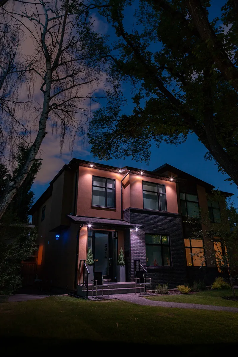 Modern home with warm white accent lighting at the roofline corners