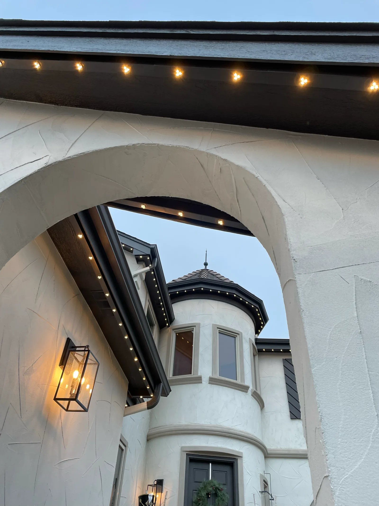 Gemstone track tucked under a stucco soffit, pixels glowing warm white